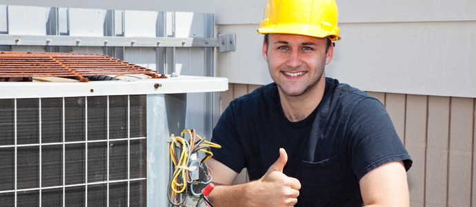 A man smiling beside an air condition