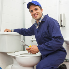 A man fixing the toilet